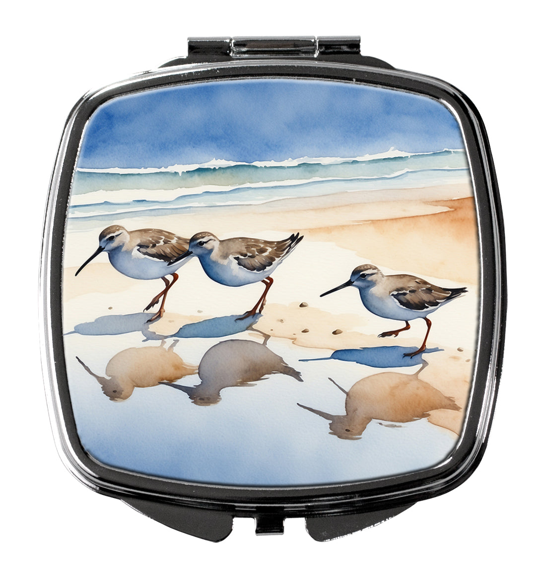 Compact mirror with a beach scene featuring birds and seals on the lid.